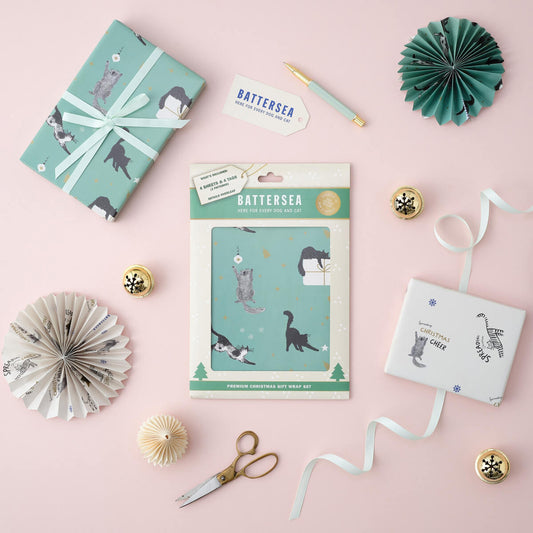 Christmas Battersea Cats Gift Wrapping Paper Set of 4 sheets - lifestyle image of pack which contain 2 different patterns
