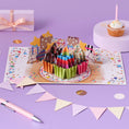 Load image into Gallery viewer, Birthday Cupcakes Pop Up Card by Cardology for Her, Him and Kids - lifestyle image with cake, bunting and confetti