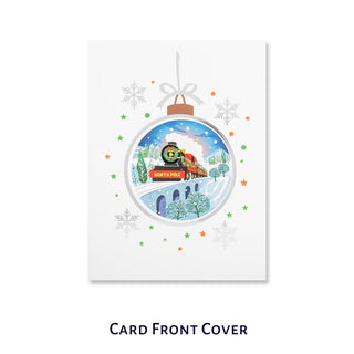 Christmas Train Pop Up Card by Cardology - close up image of the card front cover which is white with a bauble design in the center. In the middle of the bauble is a graphic image of the christmas train