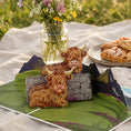 Load image into Gallery viewer, Highland Cow Pop Up 3D Card in a lifestyle setting surrounded by flowers.