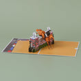 Load image into Gallery viewer, Show jumping pop up card by Cardology - lifestyle image of horse pop up card