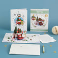 Load image into Gallery viewer, Winter Wellies Pop Up Card for gardening lovers - lifestyle image of 3D card open, with packaging, reversible envelope and notecard