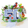 Load image into Gallery viewer, close up image of 50th birthday pop up card, soft blue with foiled silver dots on the 3D pop up 50, surrounded by butterflies, birds and insects. Inspiration of the great british countryside