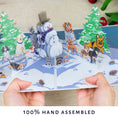 Load image into Gallery viewer, lifestyle image of Dogs Christmas Charity Battersea Card being held open