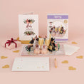 Load image into Gallery viewer, Ruby Wedding Anniversary Pop Up Card for 40th Wedding Anniversary Gift - lifestyle image with ruby anniversary pop up card with notecard and gifting envelope