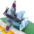 Load image into Gallery viewer, Close up image of Spitfire Pop Up Card featuring a 3D mark 9 spitfire bursting through the clouds over the white cliffs of dover