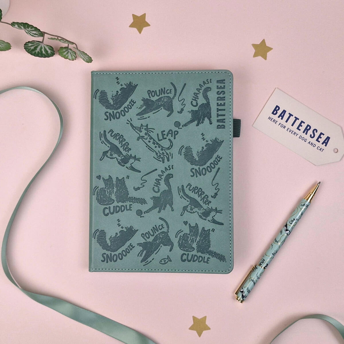 Battersea Green notebook with cat illustrations on a pink background with stars and a pen.