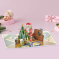 Load image into Gallery viewer, 3D charity Santa Cat pop-up Christmas card fully opened on a pink backdrop with christmas decorations
