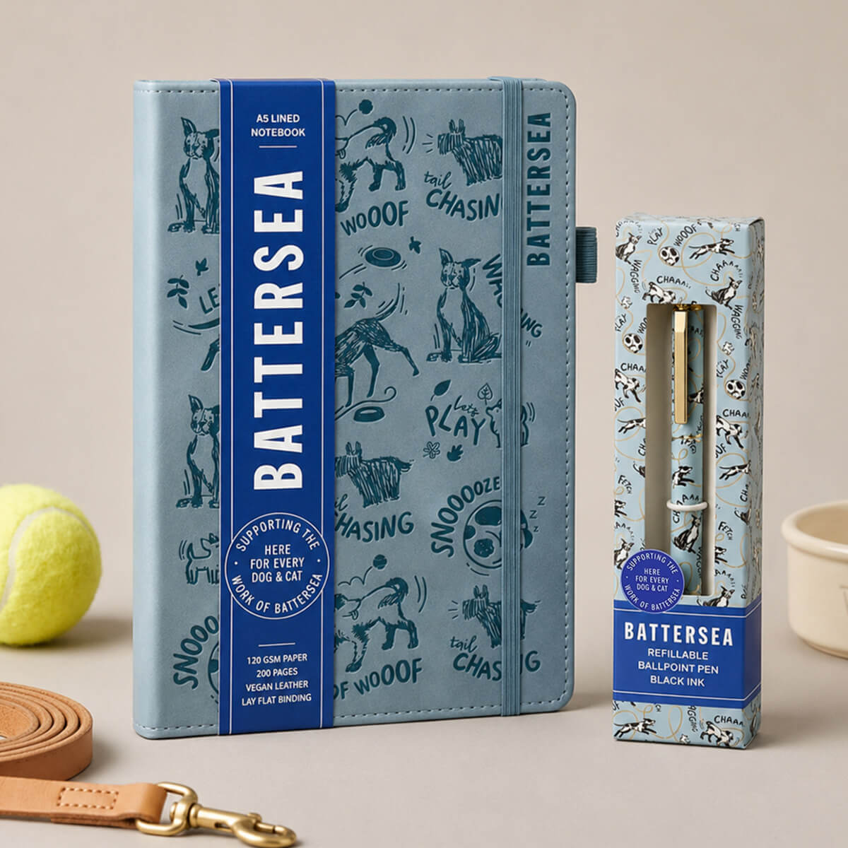 A Battersea A5-lined notebook in a dusty blue tone with black dog doodle illustrations