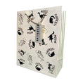 Load image into Gallery viewer, A cream gift bag with black cat illustrations and text like 'MEOW', 'STRETCH', and 'POUNCE' and golf foiling details, tied with a rope handle and a small gift tag reading 'BATTERSEA'.

