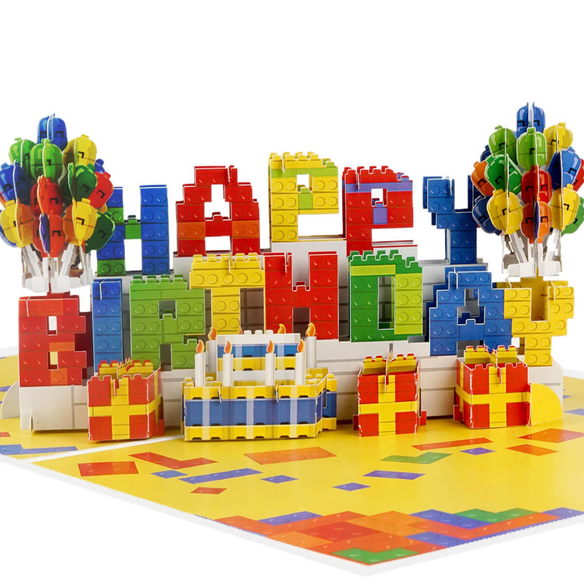 Birthday Bricks Pop Up Card for kids and adults who like building. Close up image of the pop up card which spells out Happy Birthday in colourful bricks with balloons either side.
