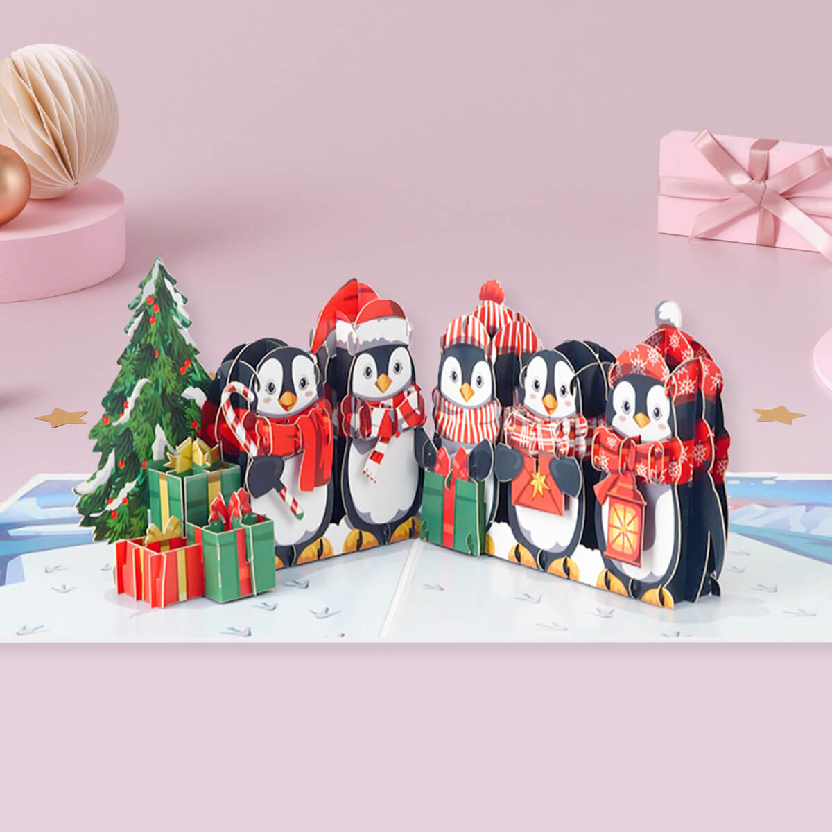 Open Penguin pop-up Christmas card featuring a 3D penguin in a snowy winter scene, holding a present next to a miniature Christmas tree
