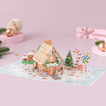 Load image into Gallery viewer, Gingerbread house 3D card with candy decorations on a pink background

