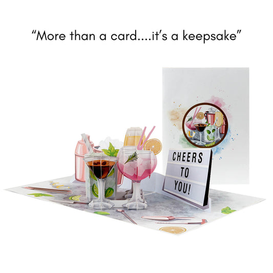 Cocktails Pop Up Card for Birthdays which includes Gin and Tonic, Martinis, Mojito, Prosecco and more in 3D, surrounded by lime and bar tools in 2D graphics.  Perfect for birthdays, Mother's Day Cards,  Congratulations, Welldone, Retirement and more occasions. Image depicts the card open with another card closed behind so you can see the card front cover graphics.