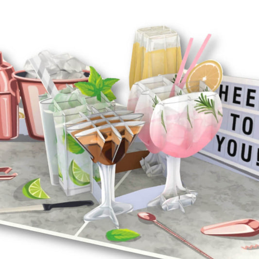 Cocktails Pop Up Card for Birthdays which includes Gin and Tonic, Martinis, Mojito, Prosecco and more in 3D, surrounded by lime and bar tools in 2D graphics.  Perfect for birthdays, Mother's Day Cards,  Congratulations, Welldone, Retirement and more occasions. Close up image of the 3D pop up part of the card