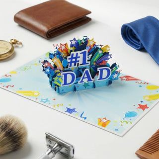 lifestyle image of the fathers day '#1 DAD' card on a table with a wallet, towel, and shaving products.