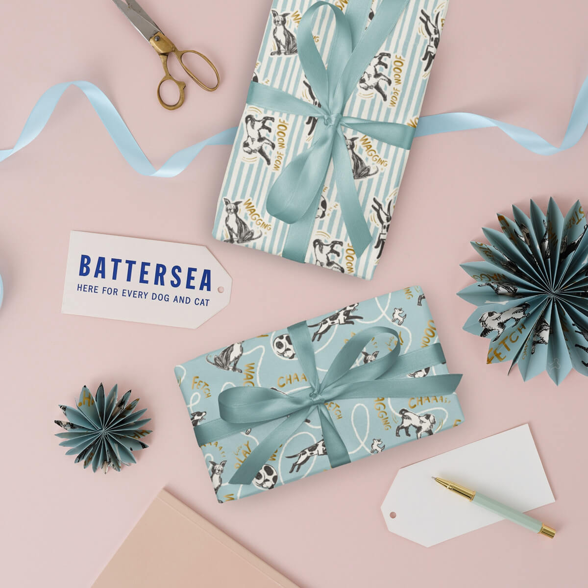 Battersea Dogs & Cats Home Gift Wrap for Dog Lovers - Pack of 4 sheets with 2 patterns. Perfect for birthdays and other celebratory occasions. Lifestyle image of both gift wrap patterns