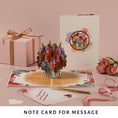 Load image into Gallery viewer, Love Bouquet Pop Up Card by Cardology - lifestyle image of 3D roses in a vase card open with the included notecard
