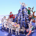 Load image into Gallery viewer, Original Stormtrooper Christmas Pop Up Card for Star Wars fans - close up lifestyle image of the pop up card highlighting the details such as stormtroopers exchanging gifts, pulling crackers, playing jokes on each other and decorating the christmas tree
