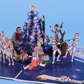 Load image into Gallery viewer, Original Stormtrooper Christmas Pop Up Card for Star Wars fans - close up lifestyle image of the pop up card highlighting the details such as stormtroopers exchanging gifts, pulling crackers, playing jokes on each other and decorating the christmas tree
