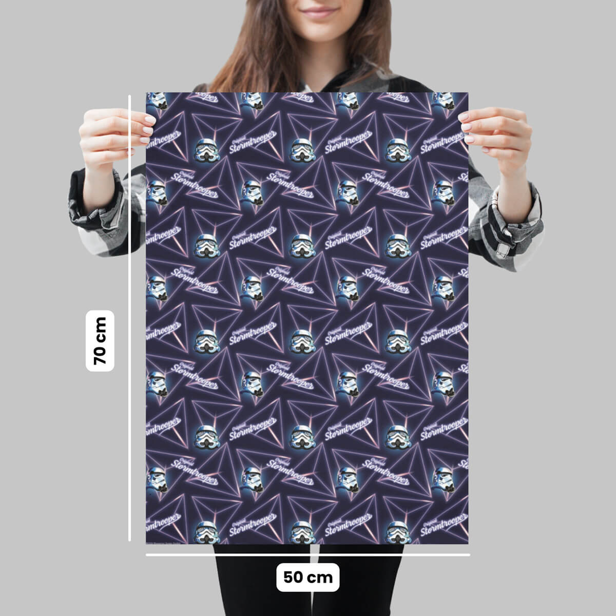 Person holding a gift wrap sheet for the Original Stormtrooper Retro design, with dimensions on a grey background