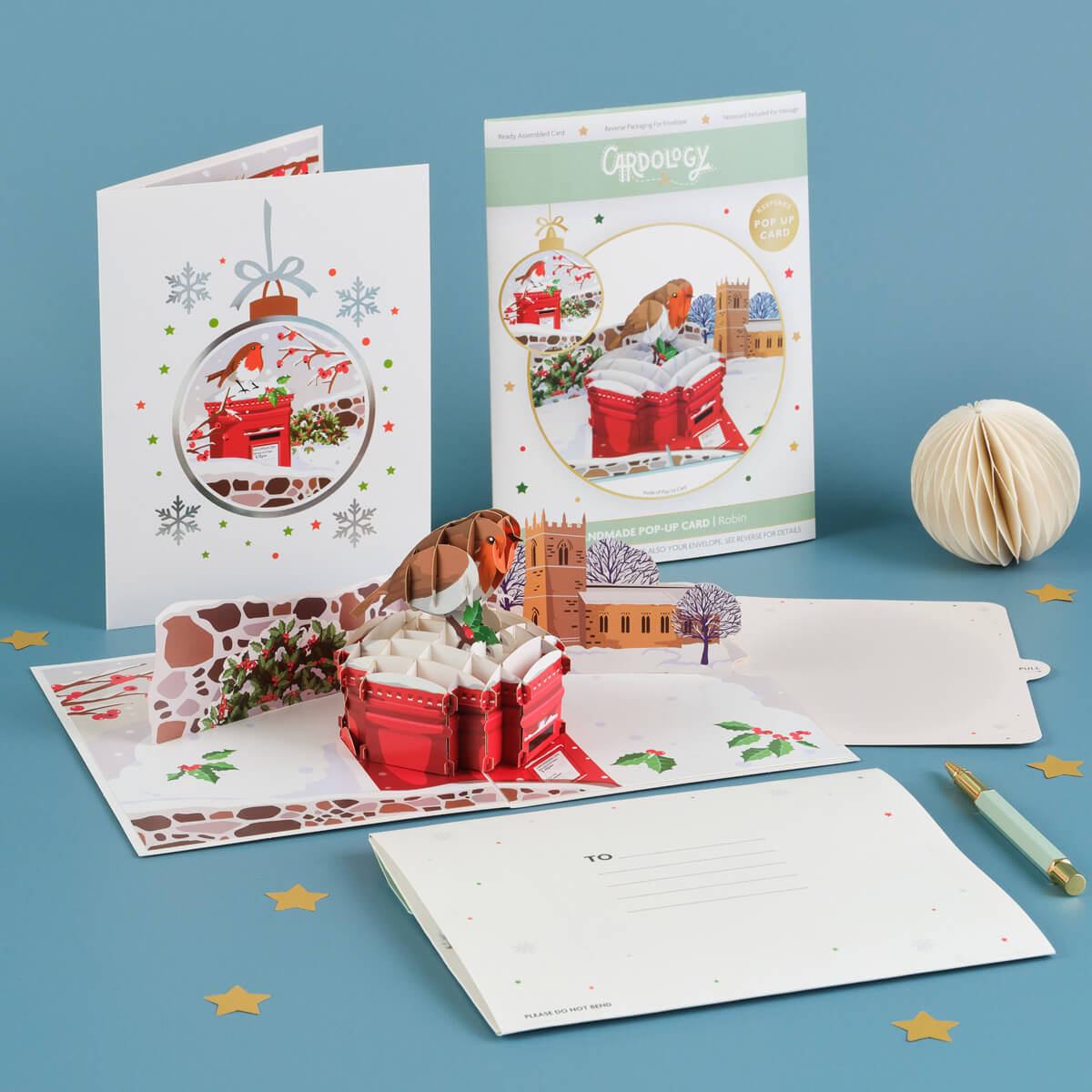 Cardology Robin Pop Up Card for Christmas - lifestyle image of the 3D Robin card which shows the card open, card front cover, notecard and reversible festive envelope