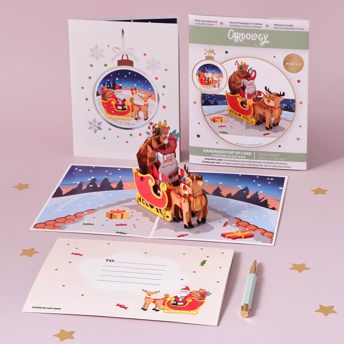 Santa Sleigh Christmas Pop Up Card with Rudolf the rednose reindeer - christmas cards - lifestyle image of card open with notecard and envelope