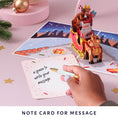 Load image into Gallery viewer, Santa Sleigh Christmas Pop Up Card with Rudolf the rednose reindeer - christmas cards - notecard on the back of the card which gives a space to write a message for the recipient
