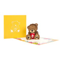 Load image into Gallery viewer, image of christening bear pop up card fully open with card cover behind
