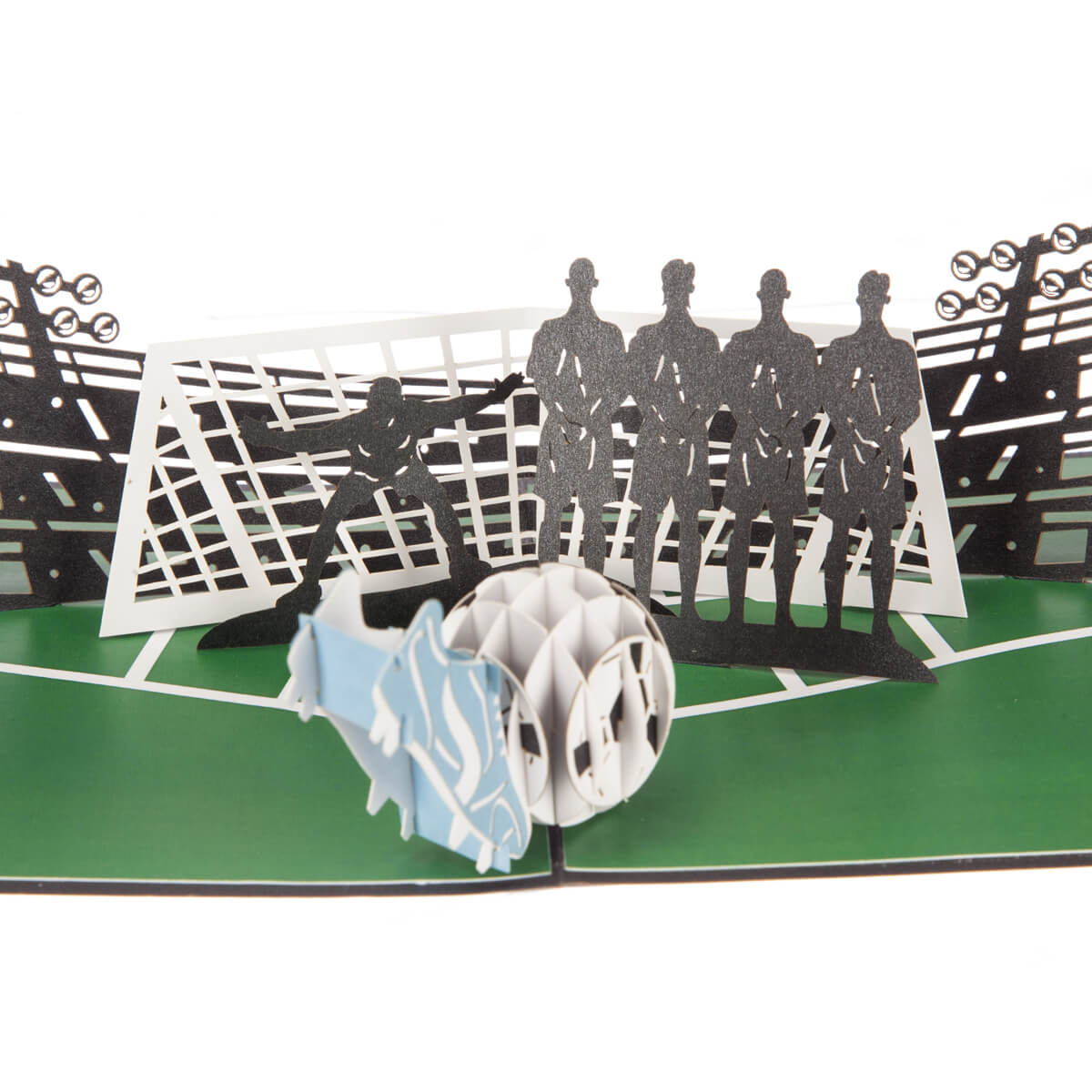close up image of football pop up birthday card featuring a 3D football and boot taking a penalty with a line of 2D defenders and a goalkeeper