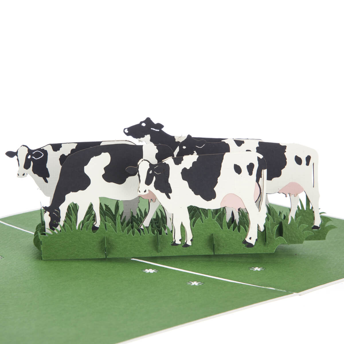 close up image of Friesian Cows Pop Up Card featuring 4 3D cows standing next to each other grazing