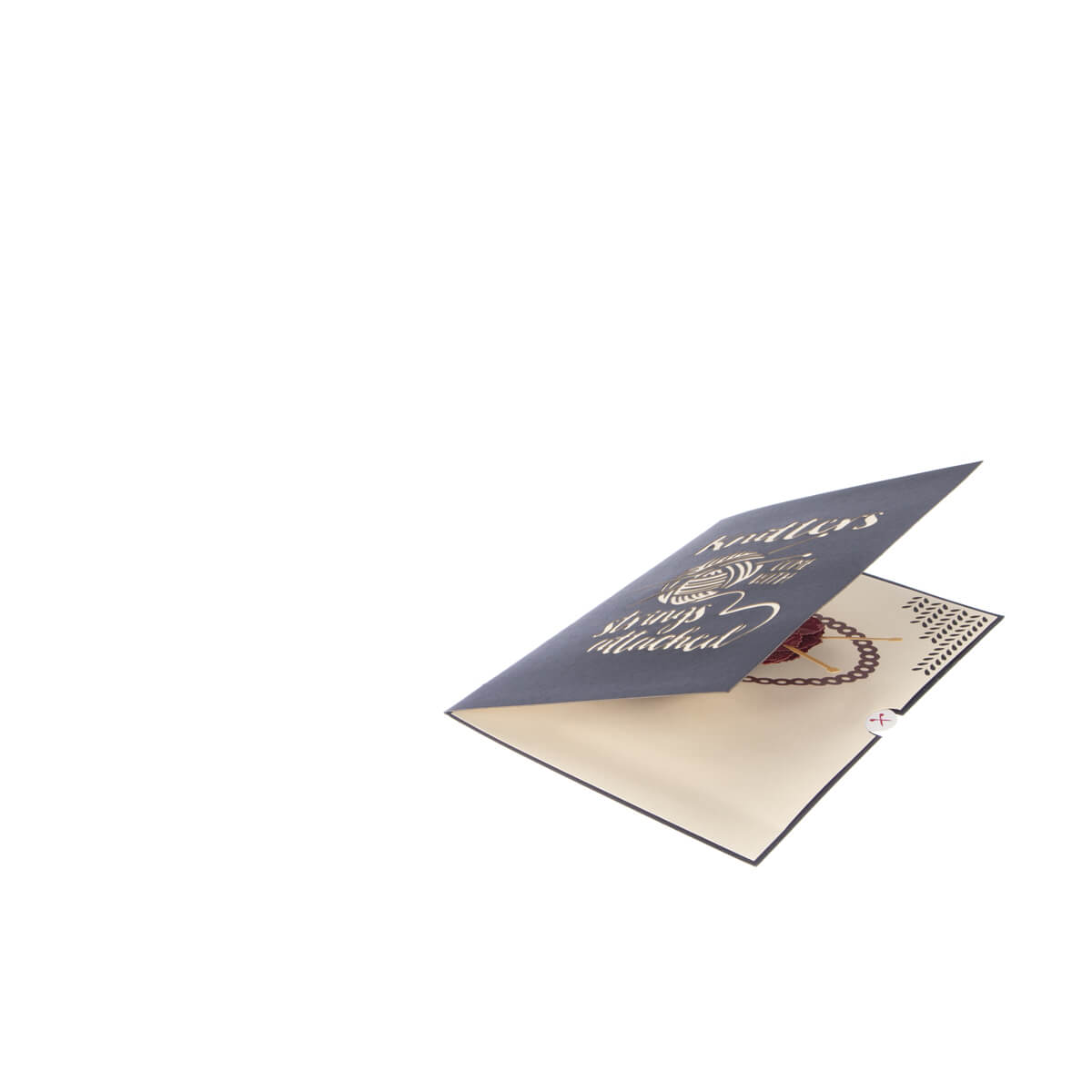 Image of Knitting Pop Up Card slightly open at 45 degrees on a white surface