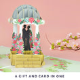 Load image into Gallery viewer, Lifestyle image of the gay wedding pagoda pop up card with flowers in the background
