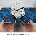 Load image into Gallery viewer, image of hands holding the stormtrooper pop up card open
