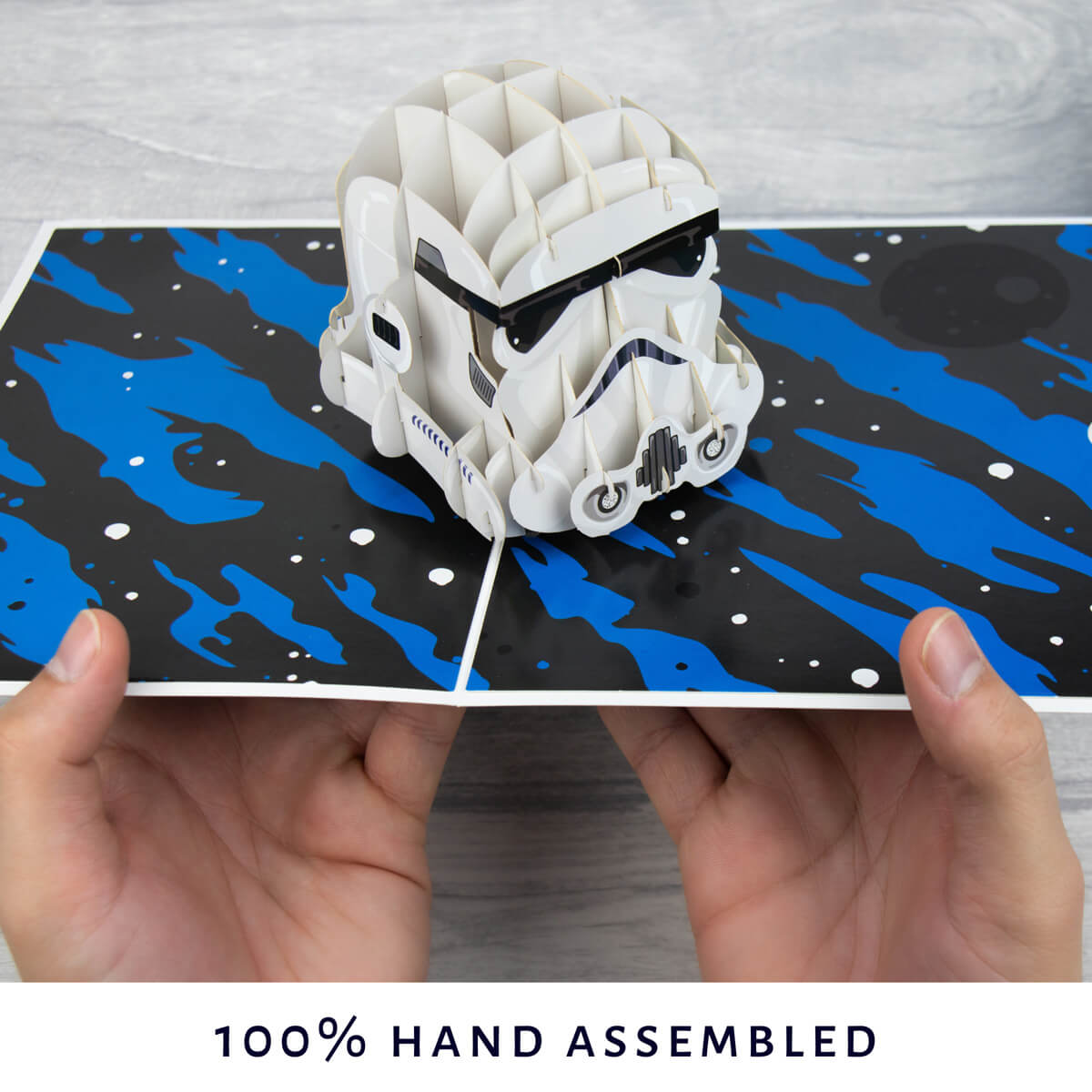 image of hands holding the stormtrooper pop up card open