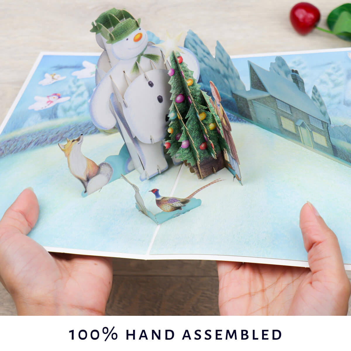 The Snowman Christmas Pop Up Card - Image of hands holding card open