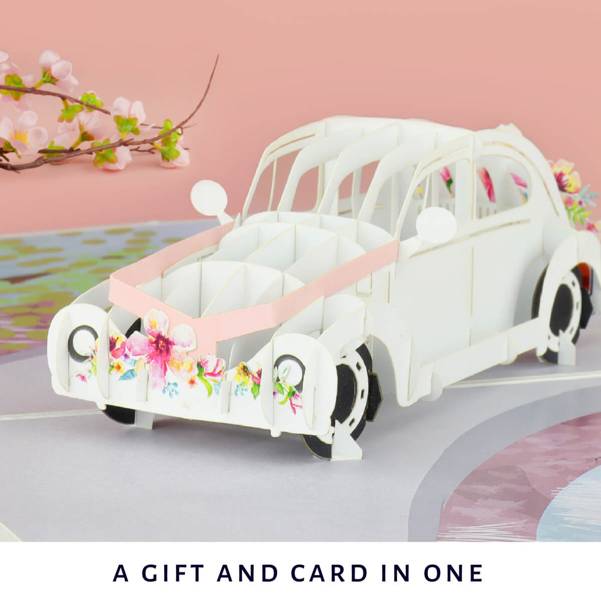 Lifestyle Image of Wedding Car Pop Up Card on pink backrop